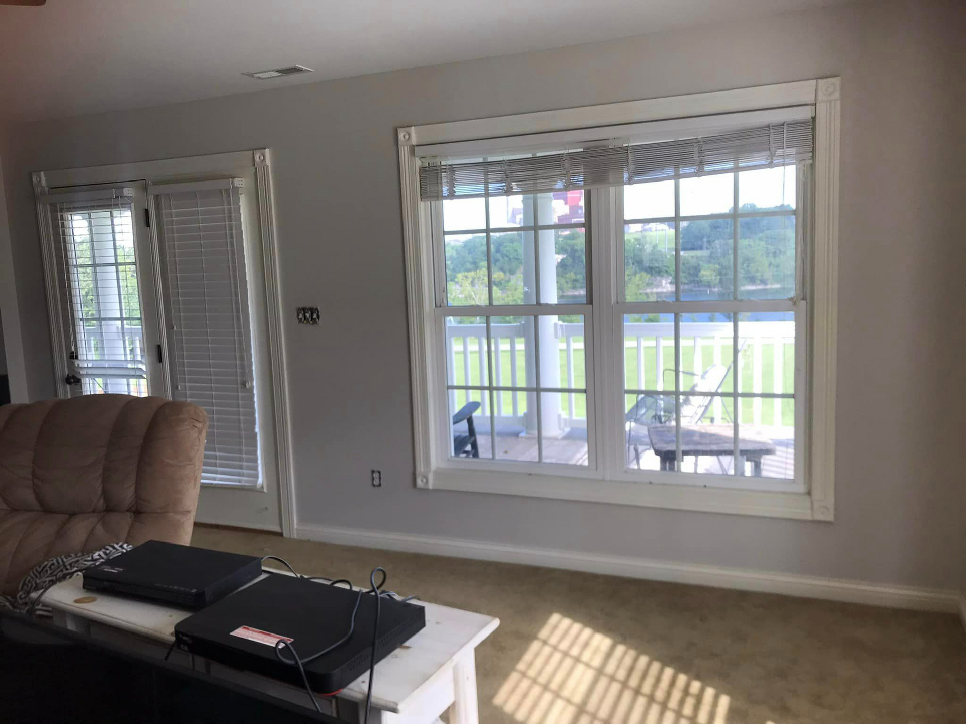 A living room with a lot of windows and a couch