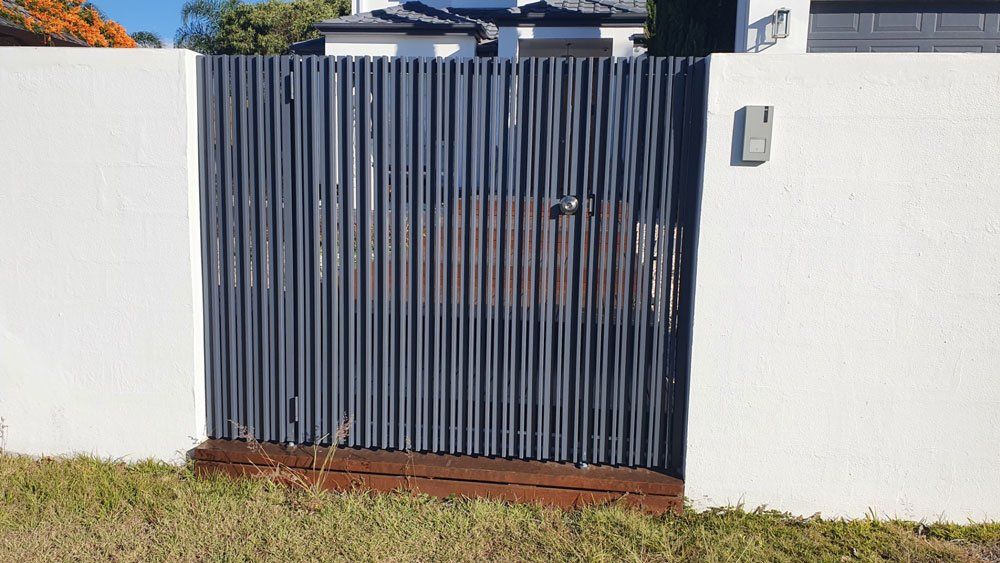 Small Aluminum Gates On The While Wall — Aluminium Gates in Burleigh Head, QLD