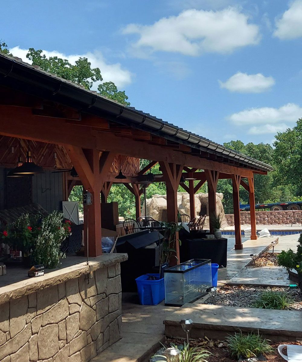 Gutters protect a covered patio area with a swimming pool 