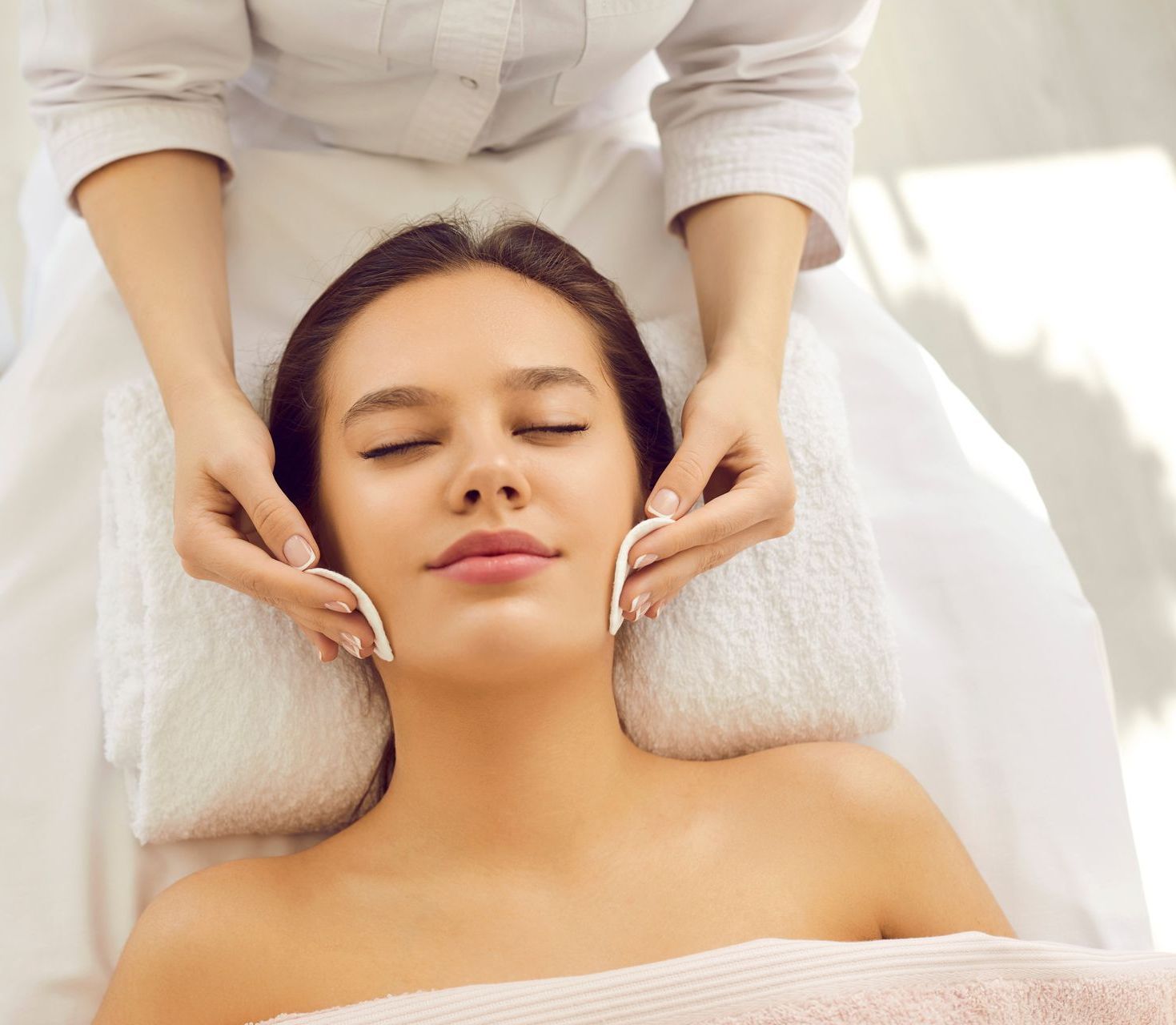 A woman is getting a facial treatment at a spa.