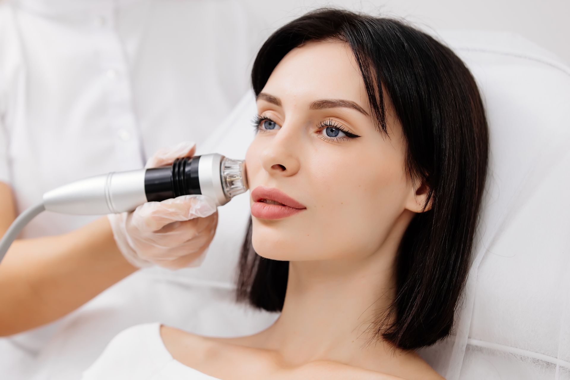 A woman is getting a facial treatment in a beauty salon.