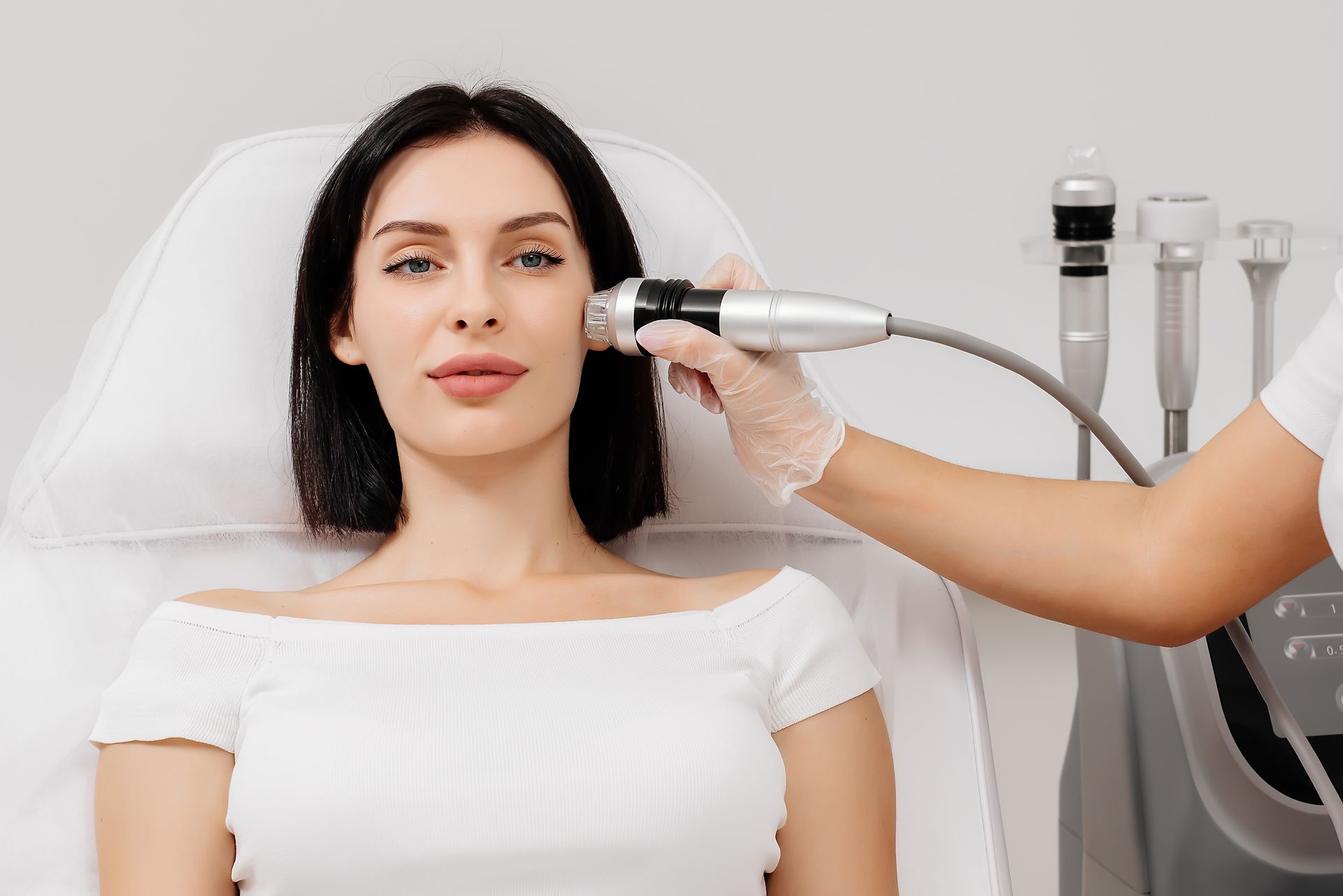 A woman is getting a facial treatment at a beauty salon.