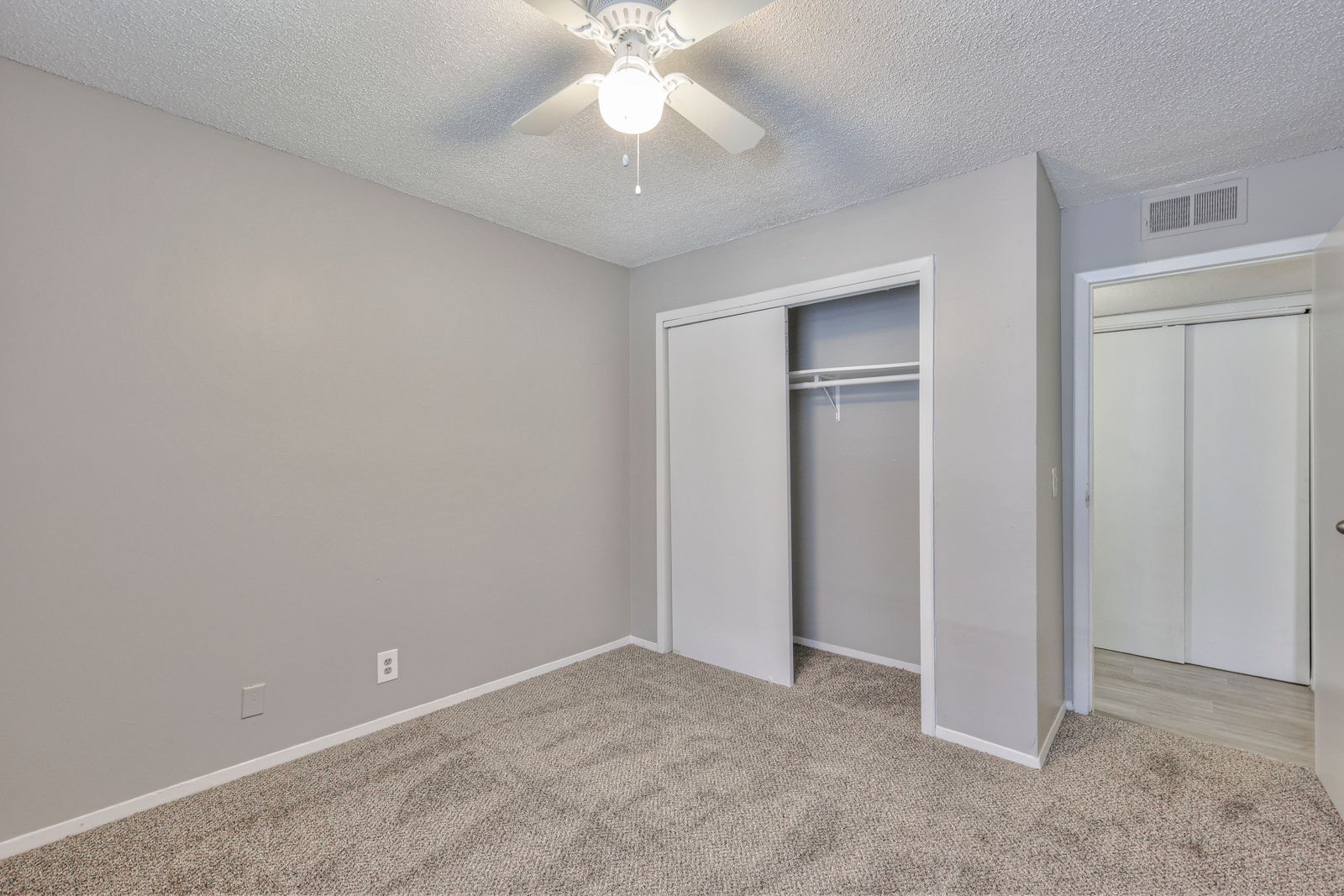 Photo of a bedroom with a sliding door closet