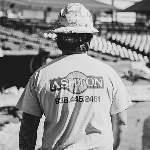 A worker wearing a t-shirt of Ashton Sawing & Drilling LLC in Dallas, TX