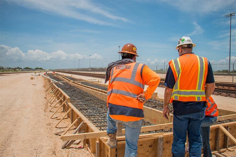 Two Construction workers working on a construction site in Texas and Louisiana.