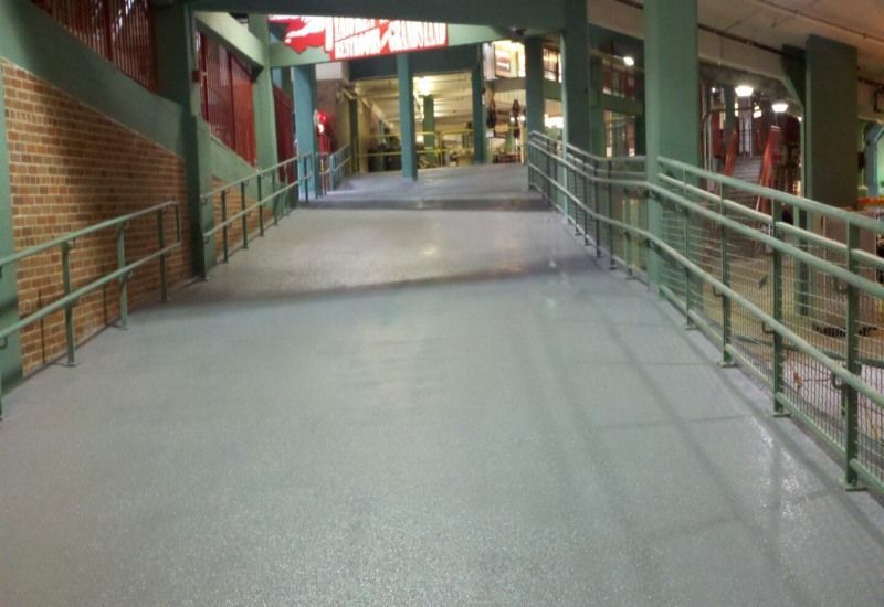 Ramp leading to a building entrance with metal railings and brick walls at dusk