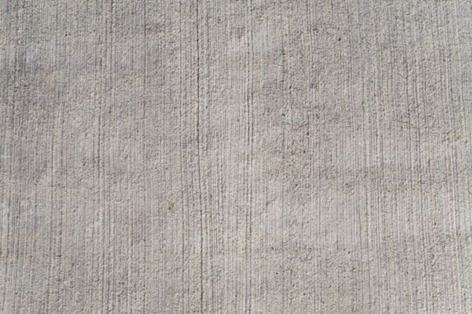 Light gray textured fabric surface with fine vertical weave pattern