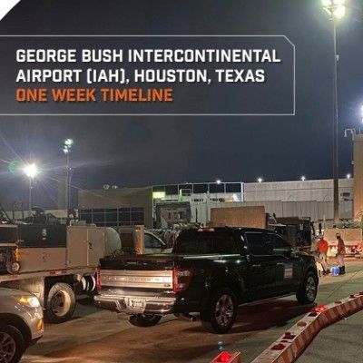 George Bush Intercontinental Airport at night, with trucks and construction equipment in an airport work zone.