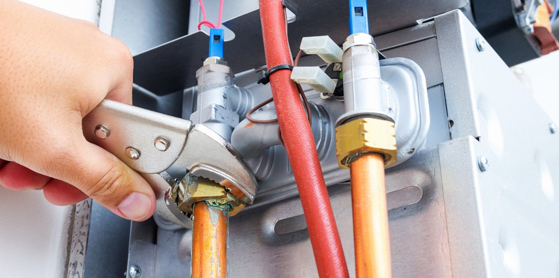 Plumber Repairing A Gas Boiler — West Ivins, UT — Airco Heating & Cooling Inc Plumber Repairing A Gas Boiler — West Ivins, UT — Airco Heating & Cooling Inc