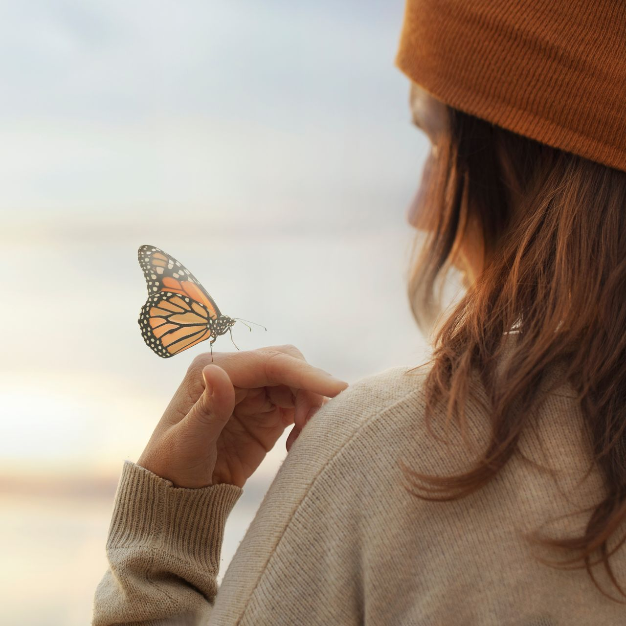 women with butterfly on hand
