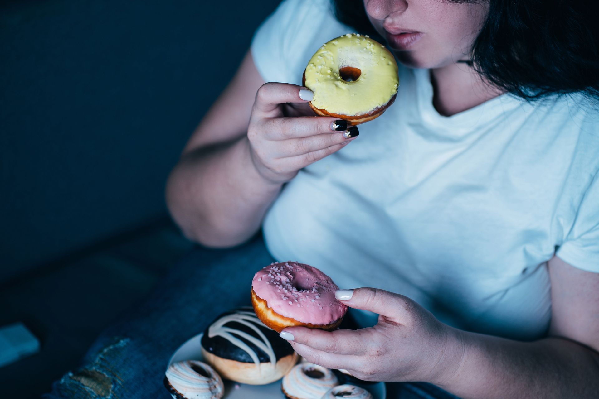 woman emotional eating donuts