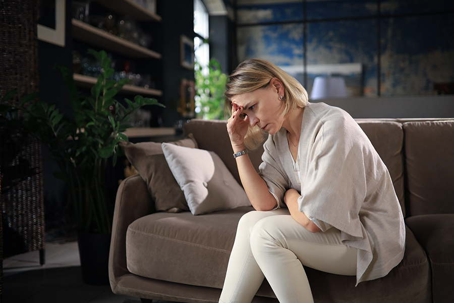 midlife woman on sofa in contemplation