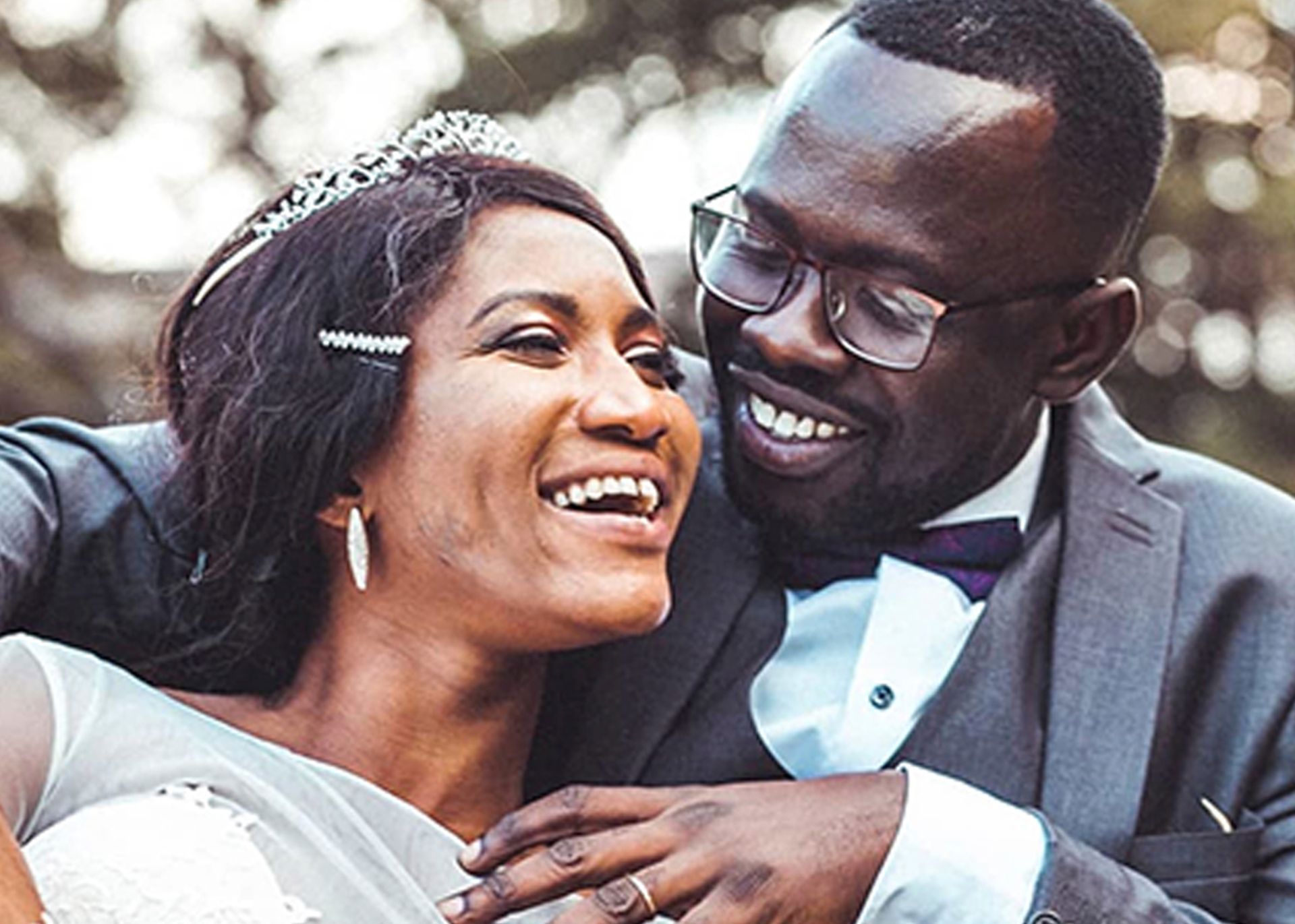 A bride and groom are posing for a picture on their wedding day.