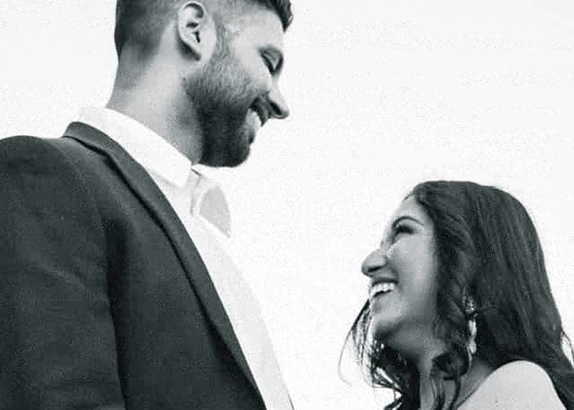 A black and white photo of a bride and groom looking at each other.
