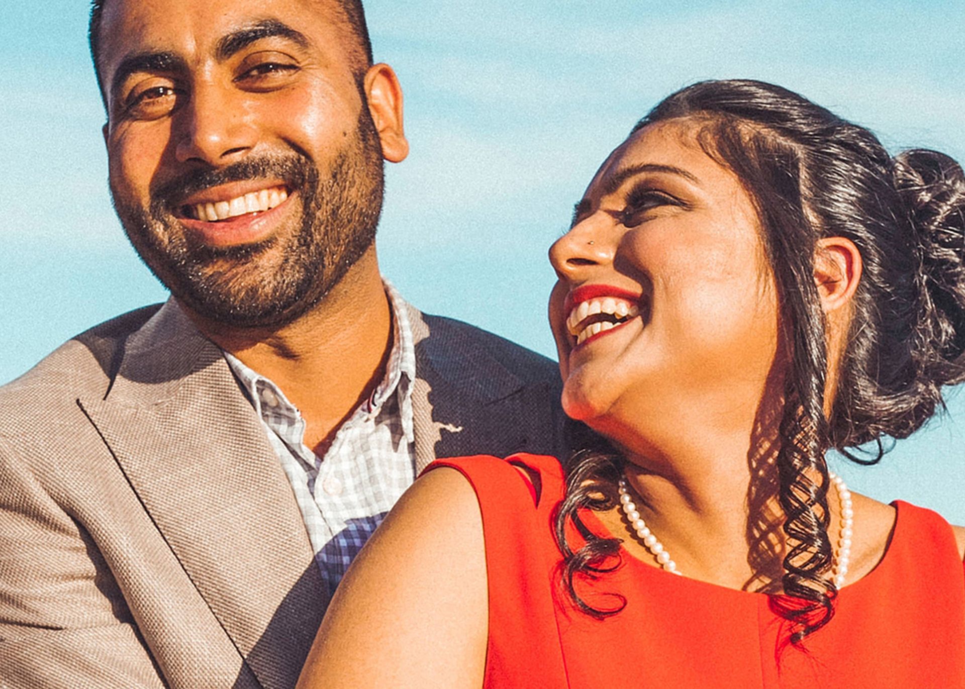 A man and a woman are standing next to each other and smiling.