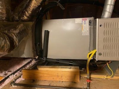 HVAC furnace in attic with ductwork, vents, and yellow gas line beside wooden beam