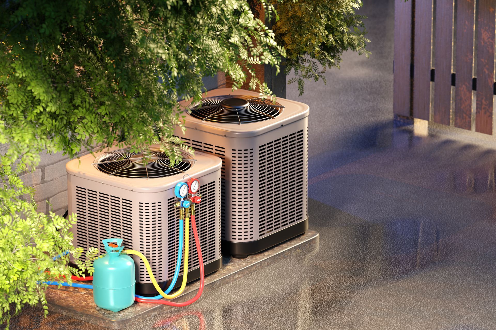 Two outdoor air conditioning units beside a tree, with colorful hoses and a blue watering can on a wet ground.