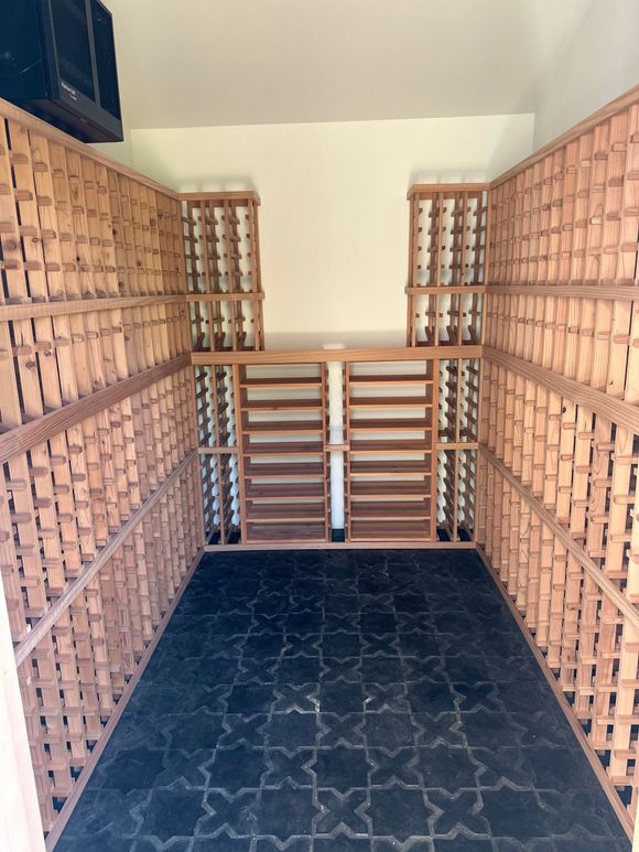 An empty wine cellar with lots of wooden shelves