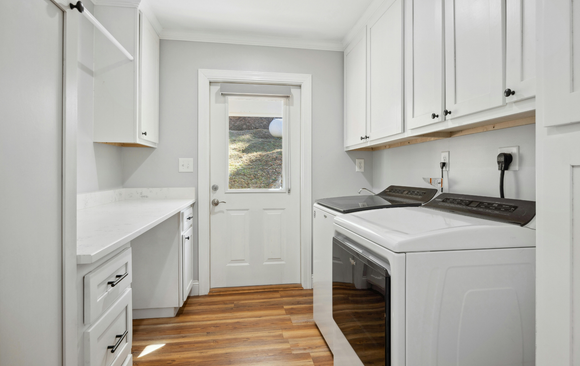 There is a laundry room with a washer and dryer.