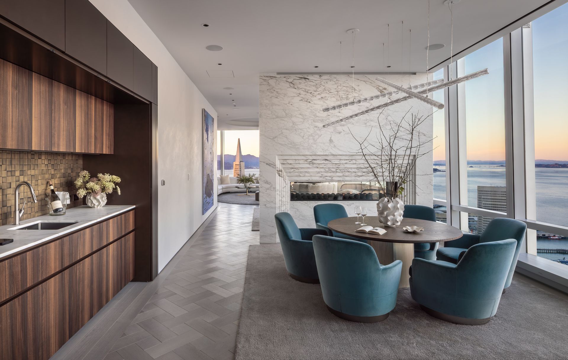 A dining room with a table and chairs and a view of the ocean