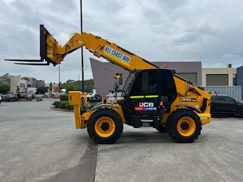 A yellow JCB telehandler parked outdoors with its telescopic boom raised, featuring 