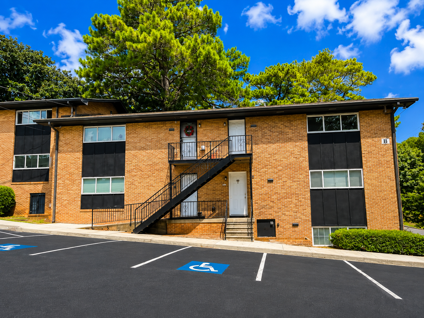 Chat GPT Image of a two-story building, showing front doors and windows and the inclined parking lot out front