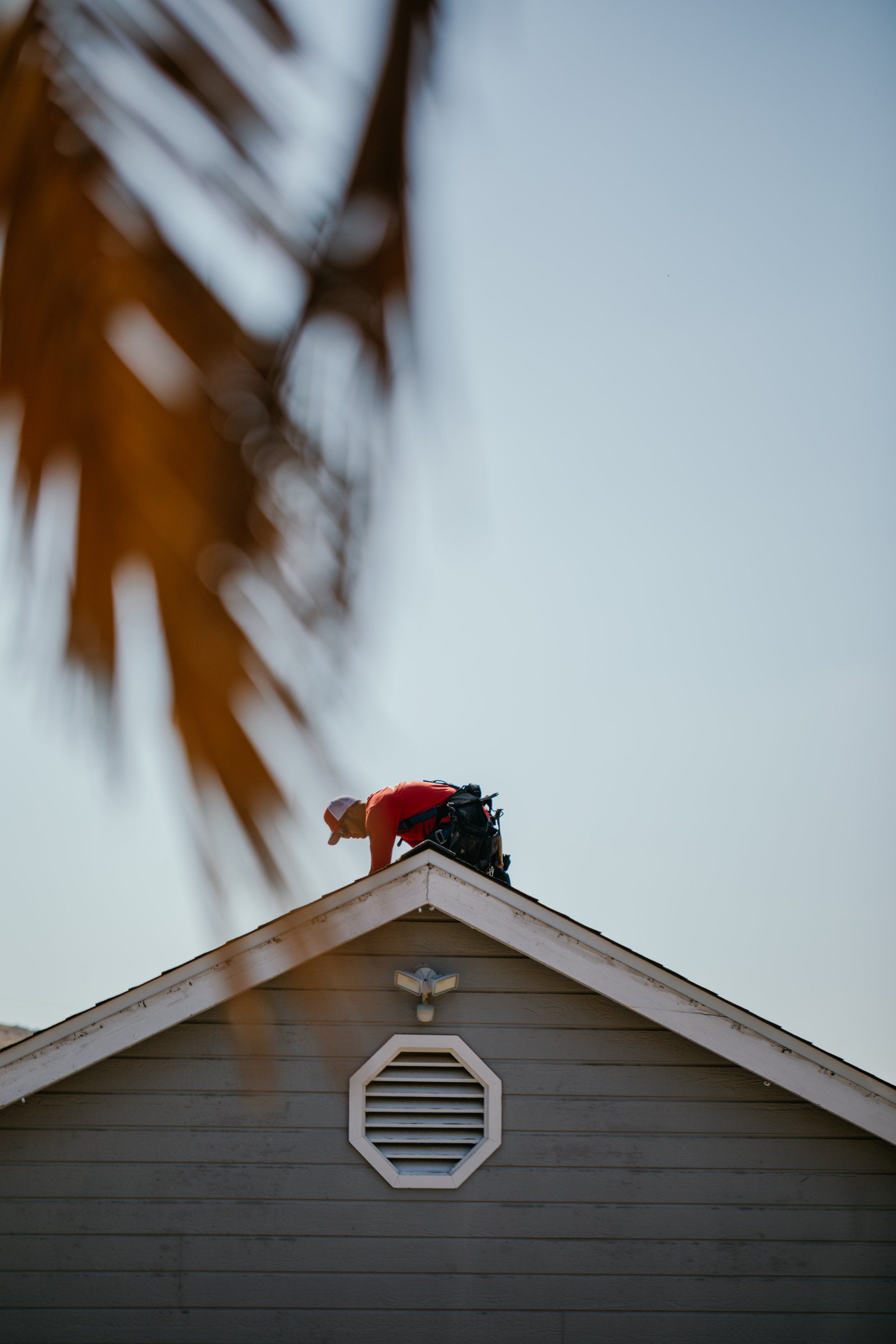 A man is working on the roof of a house