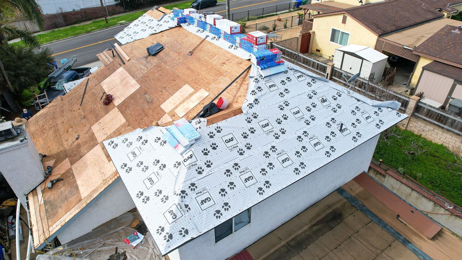 An aerial view of a roof being installed on a house