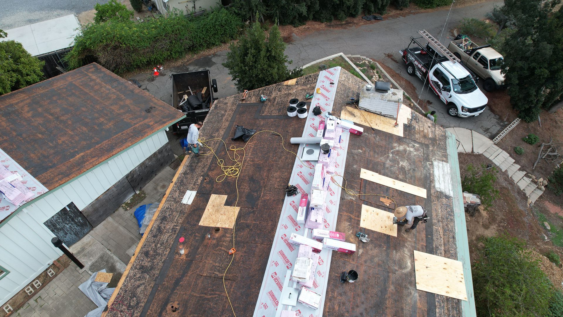 An aerial view of a roof that is being repaired