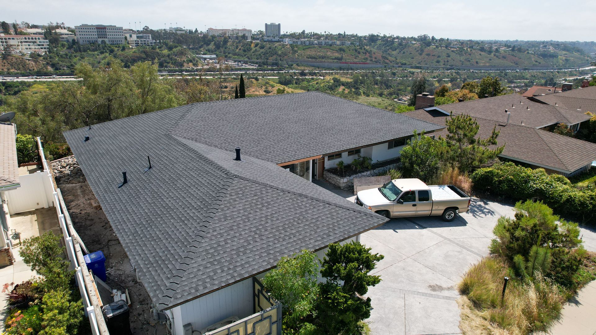 An aerial view of a house with a car parked in front of it