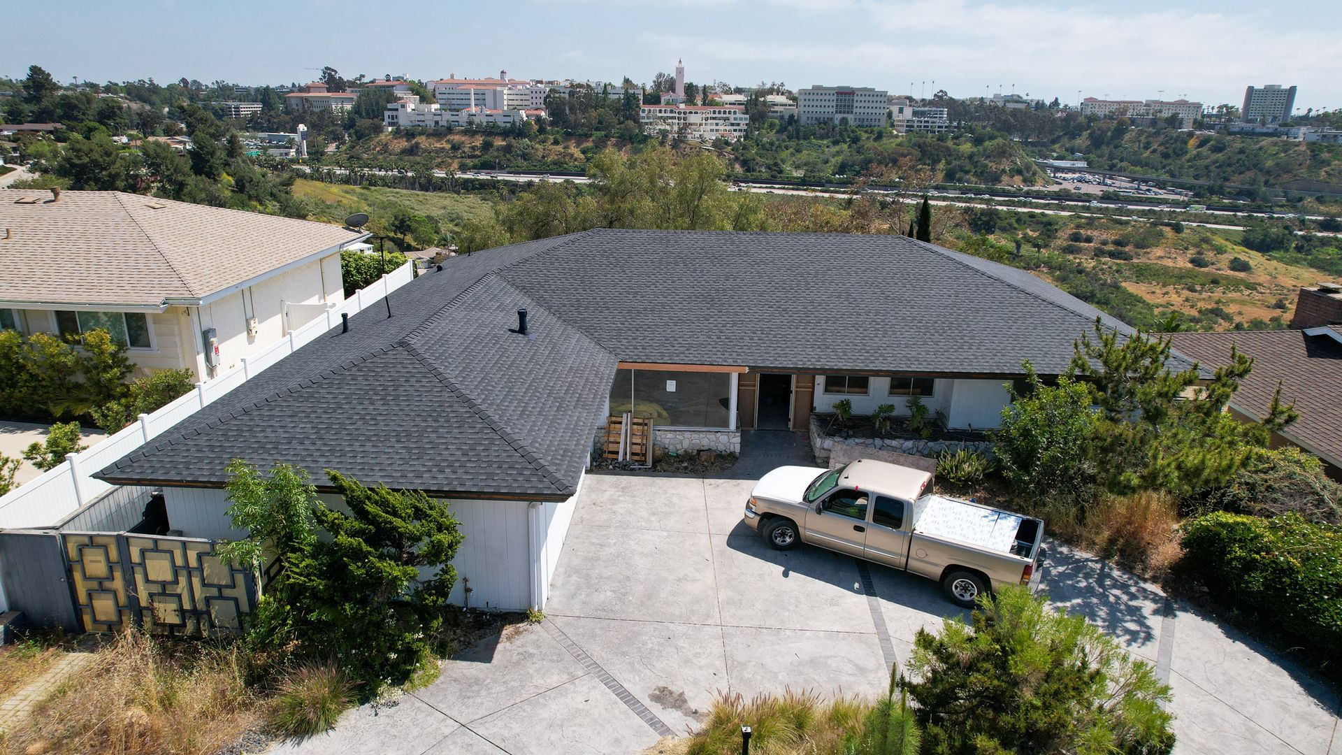 An aerial view of a house with a truck parked in front of it