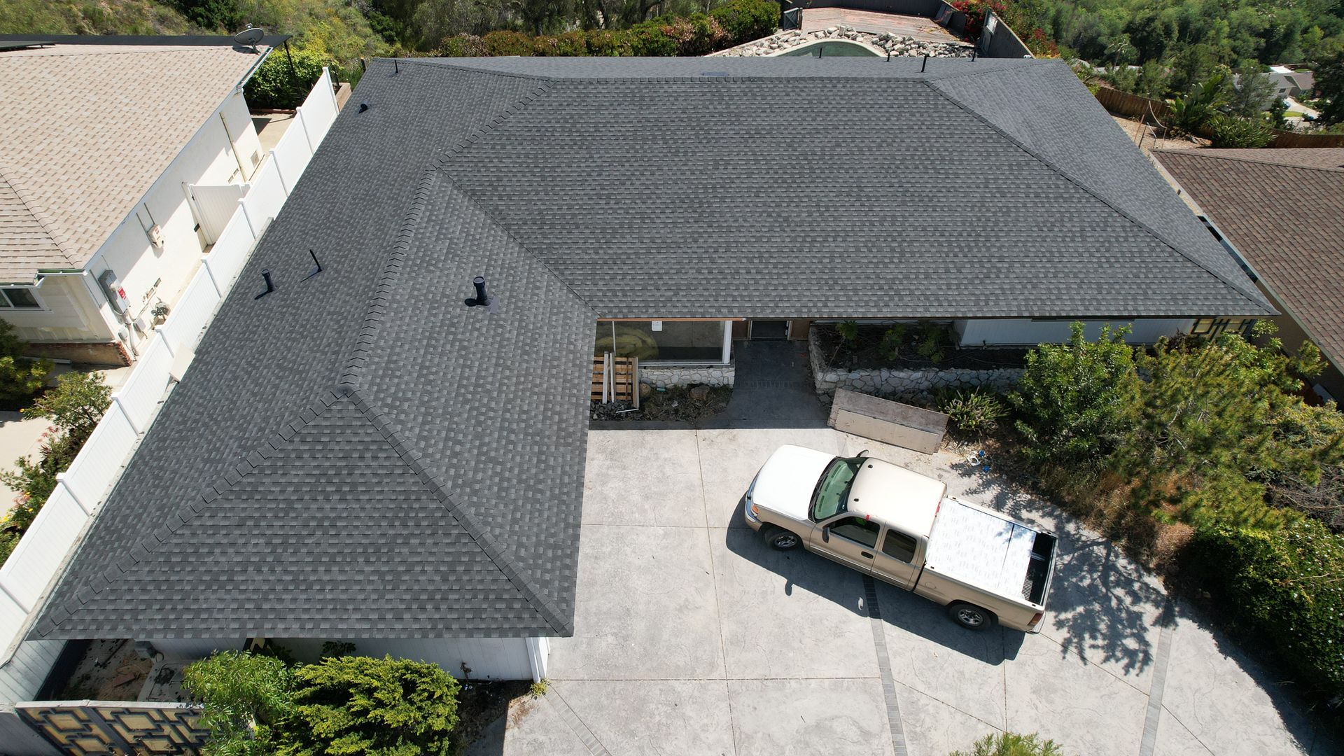 An aerial view of a house with a car parked in front of it