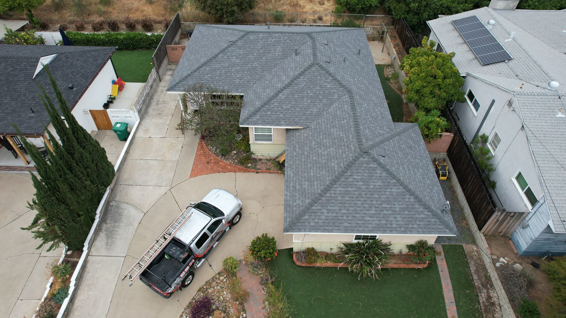 An aerial view of a house with a truck parked in front of it