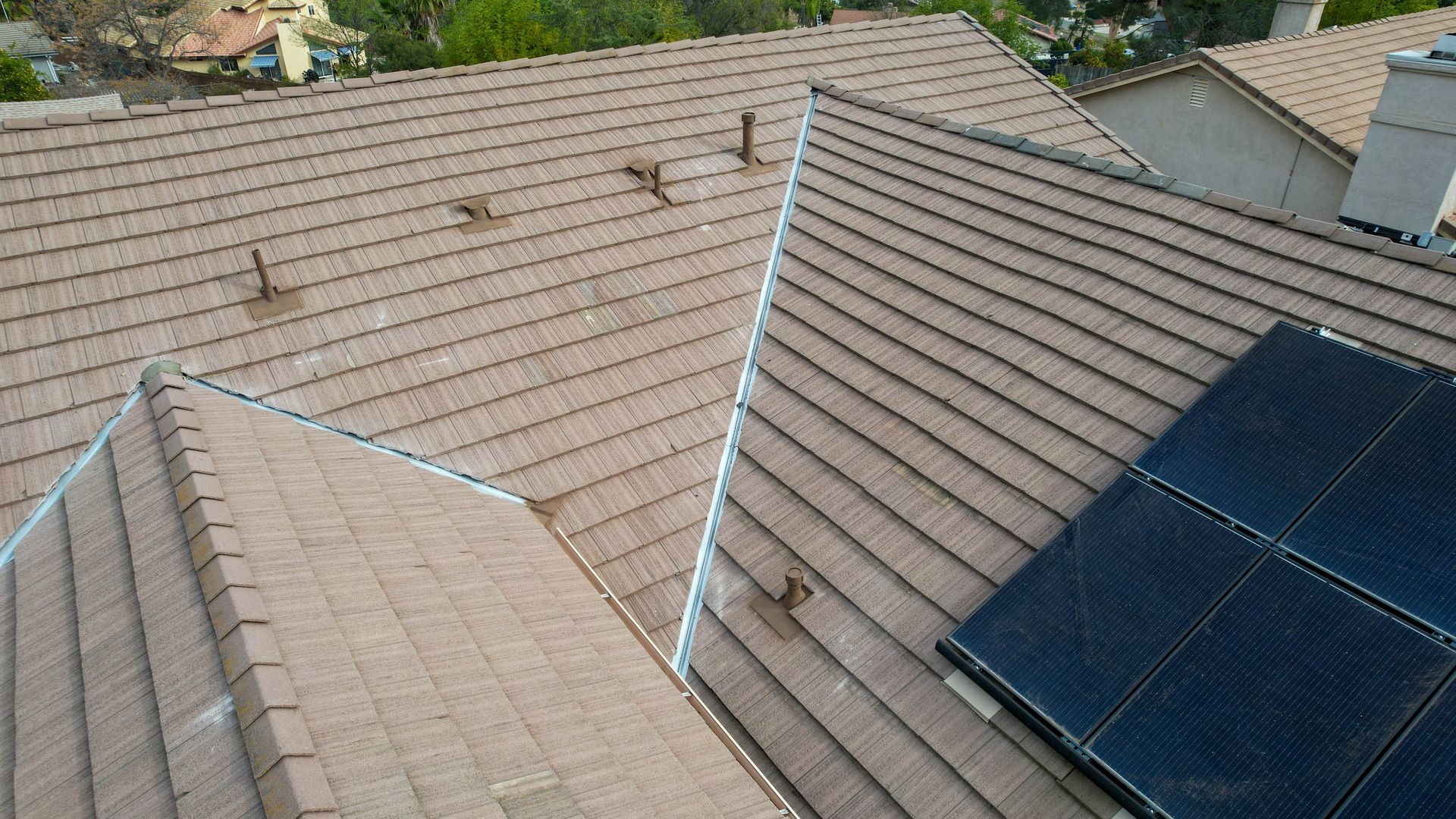 A roof with a few solar panels on it