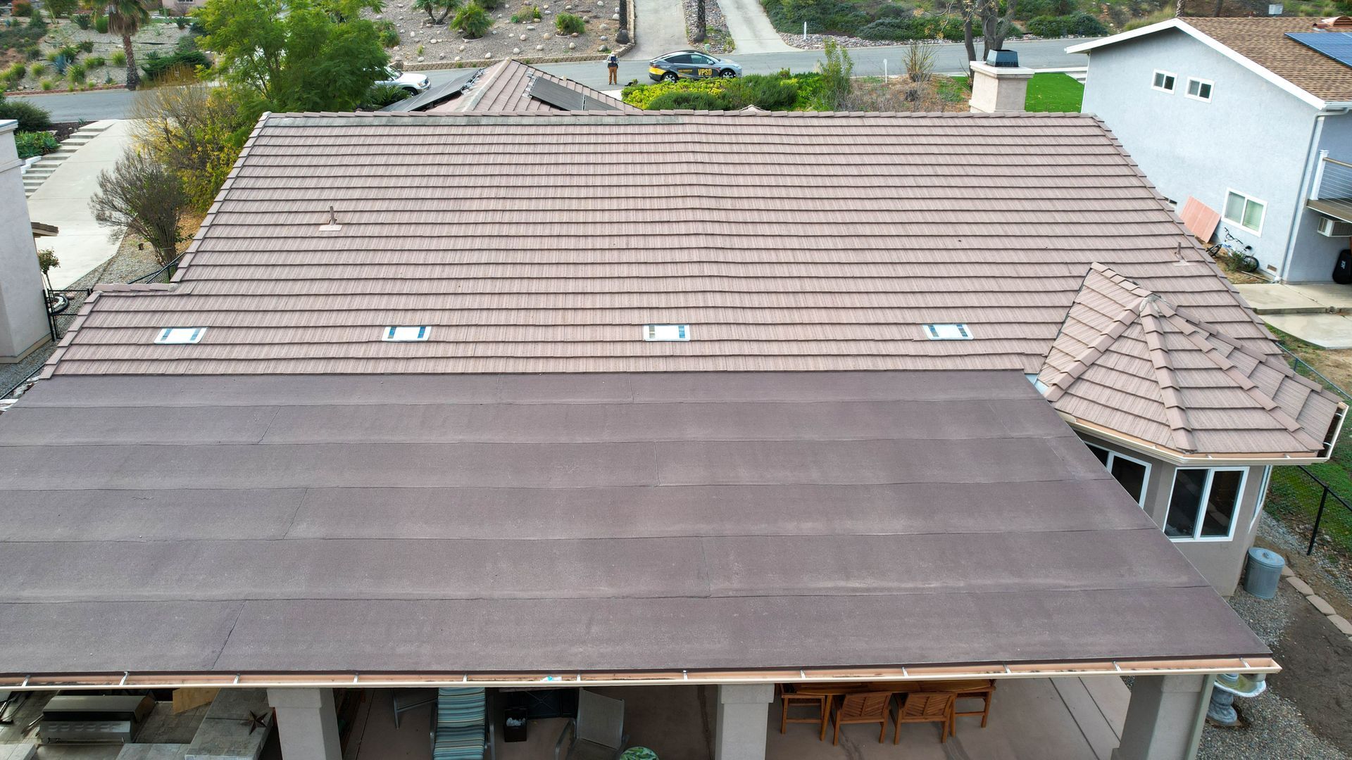 An aerial view of a house with a brown roof