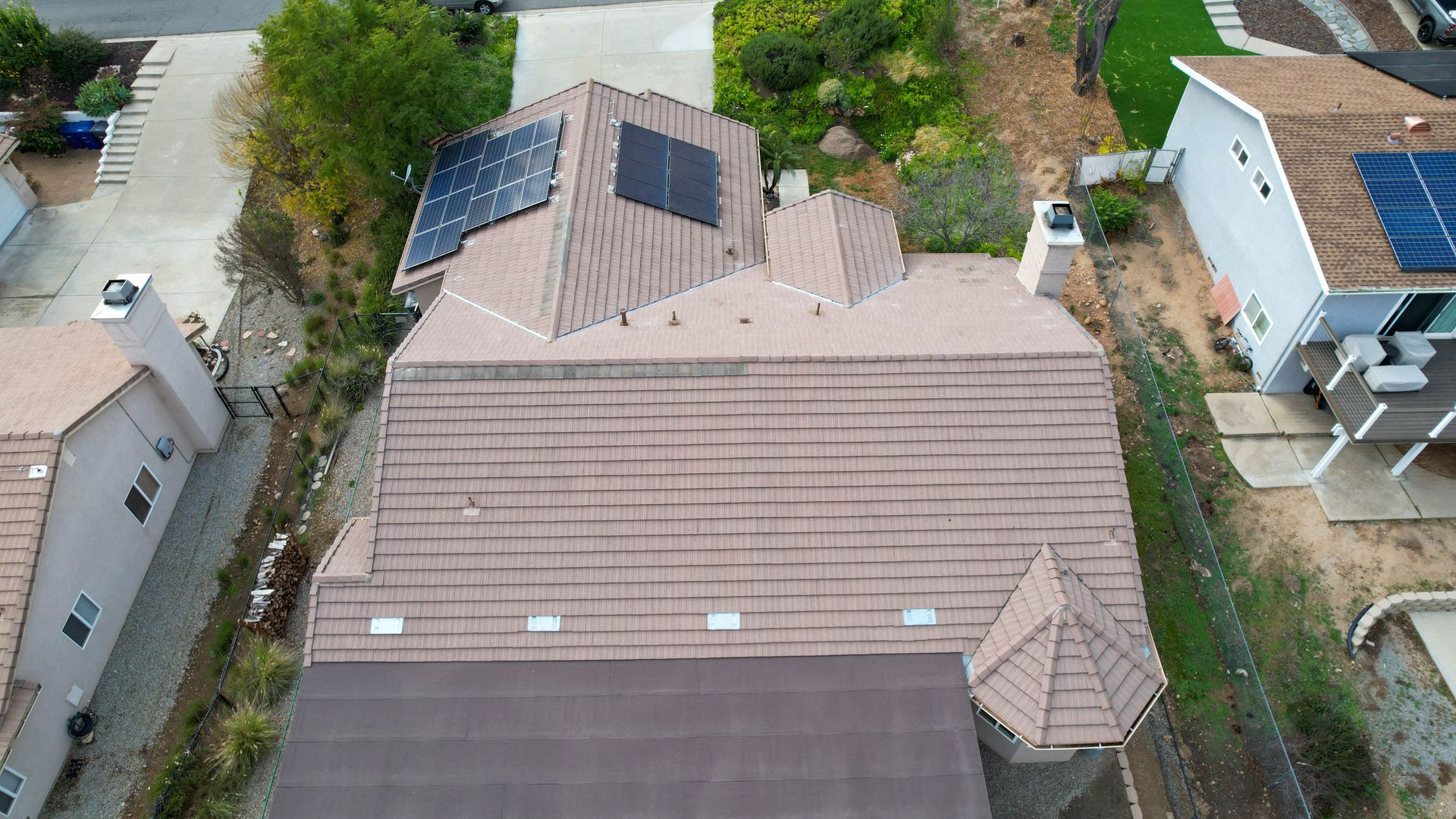 An aerial view of a house with solar panels on the roof