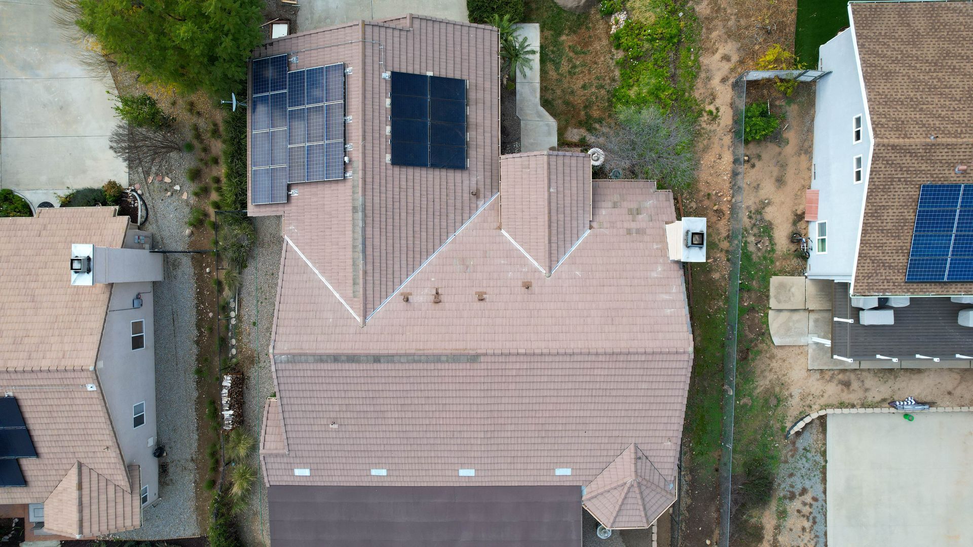 An aerial view of a house with solar panels on the roof