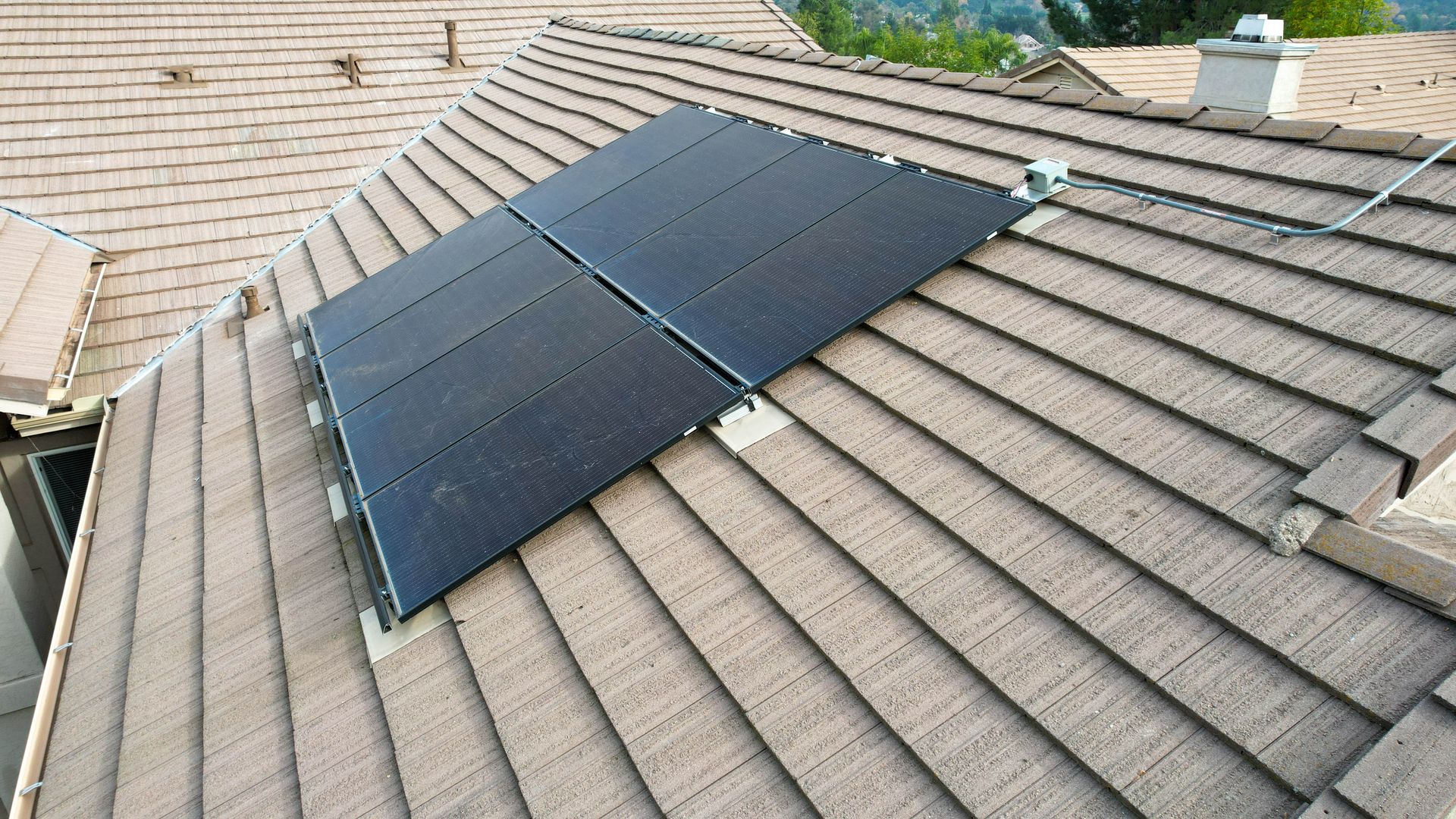 A solar panel is sitting on the roof of a house