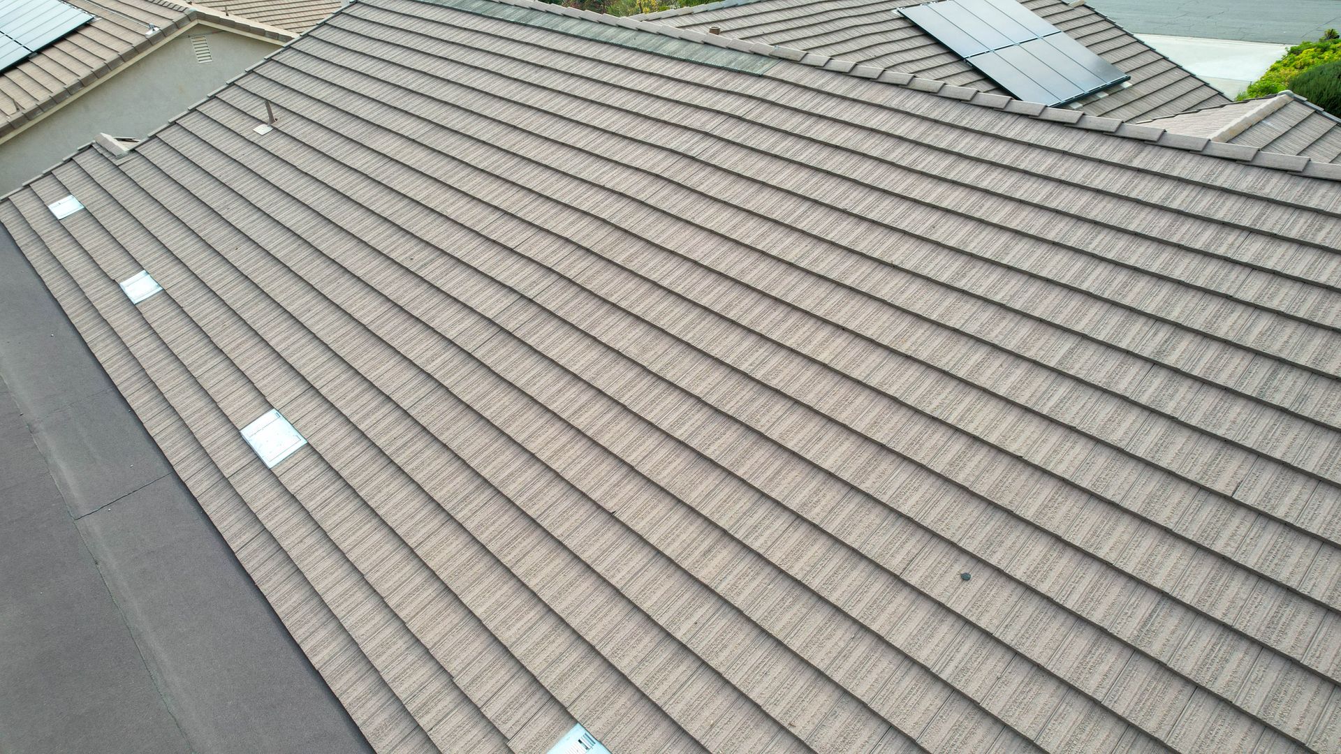A roof with a lot of tiles and solar panels on it