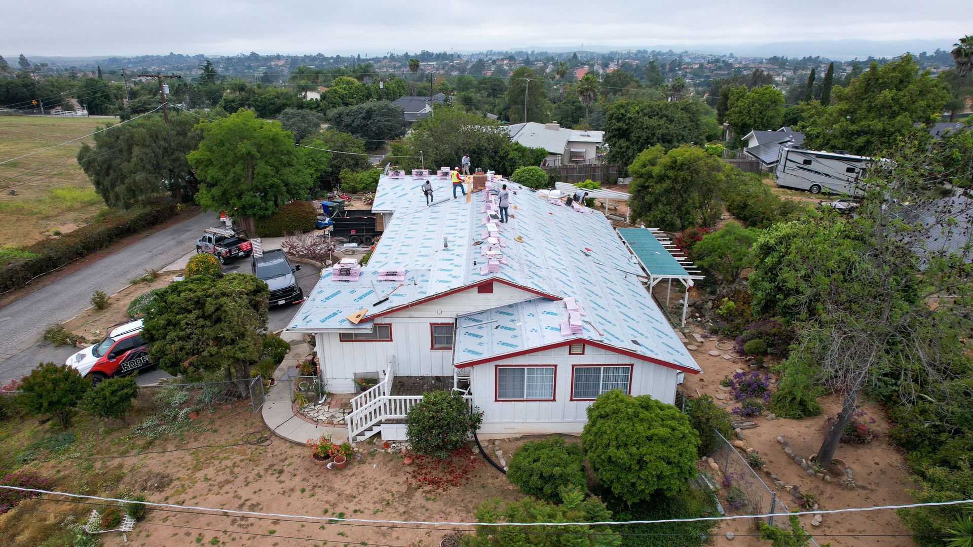 An aerial view of a house with a blue roof