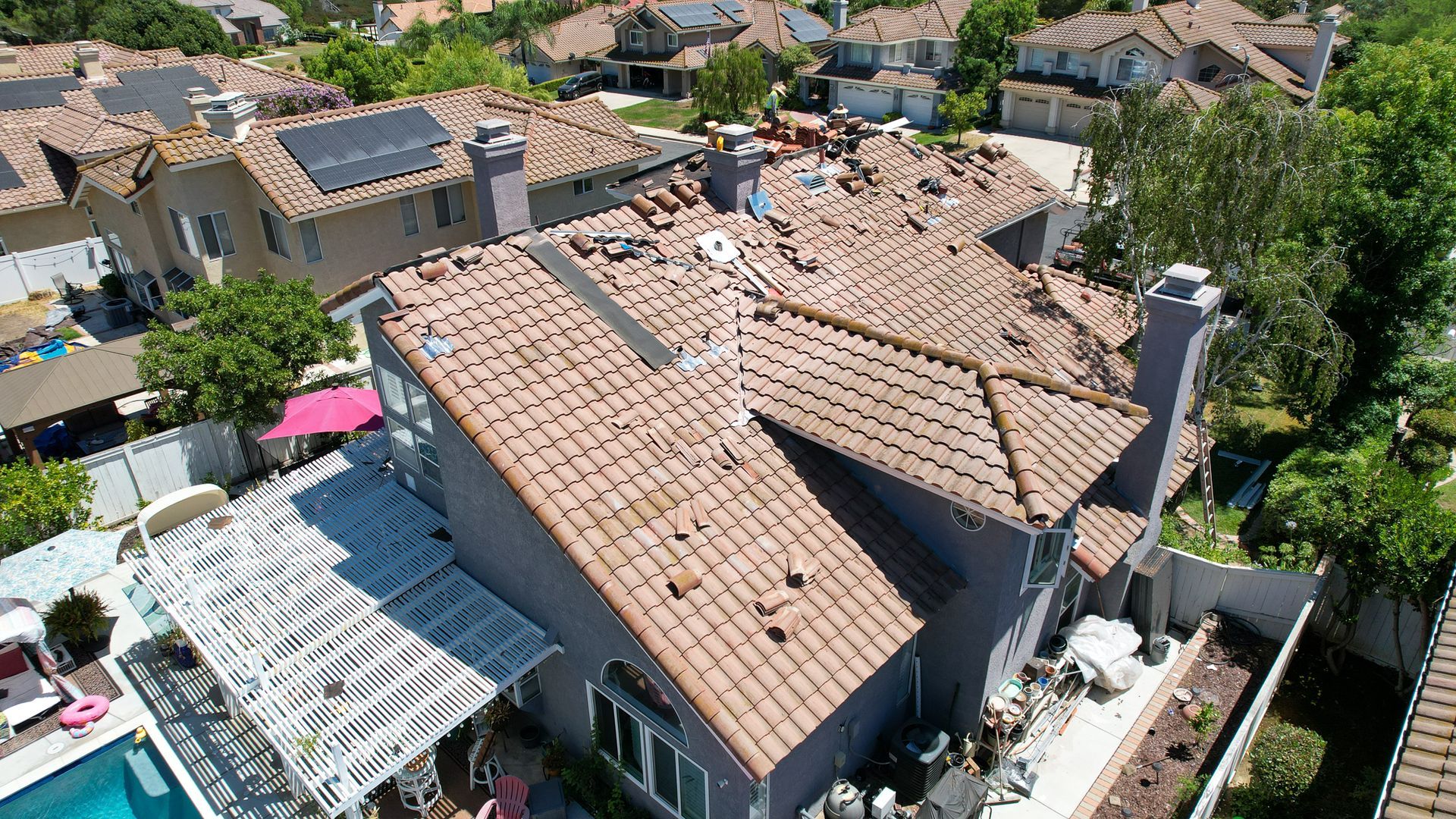 An aerial view of a house with solar panels on the roof