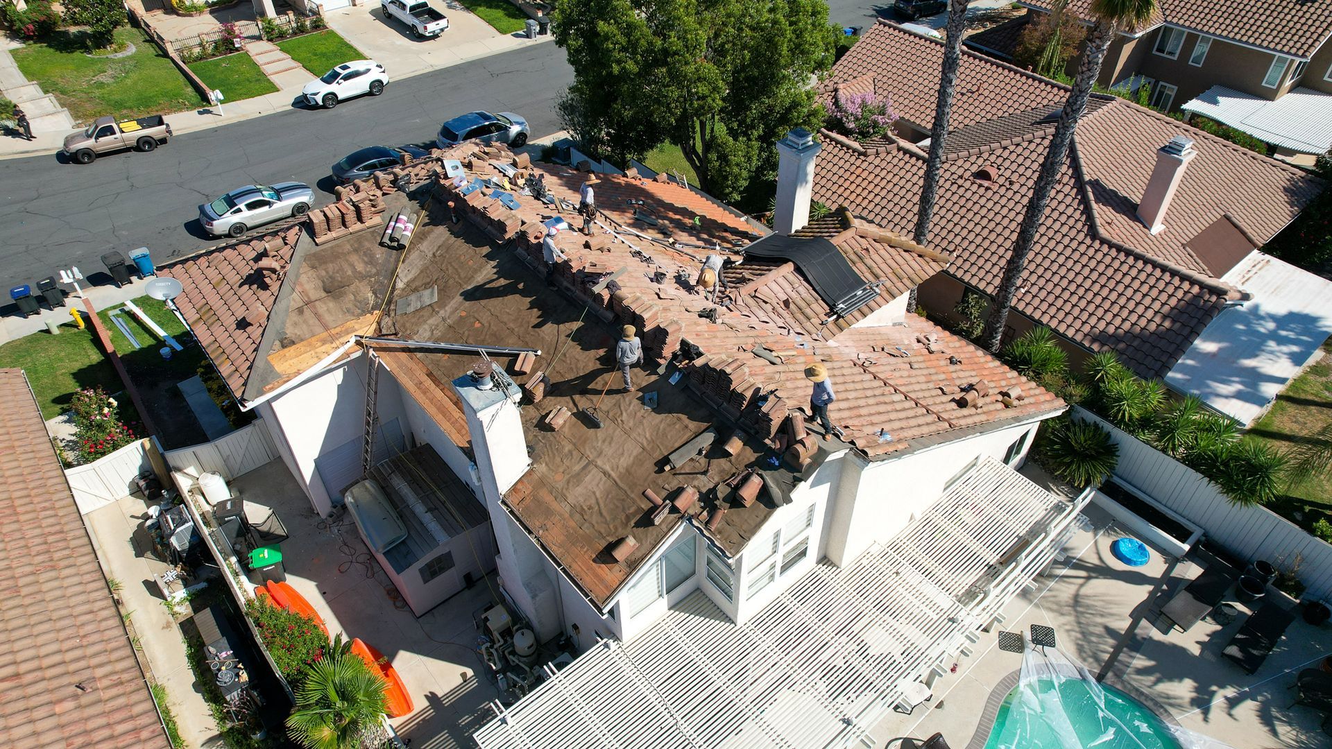 An aerial view of a house with a pool in the backyard