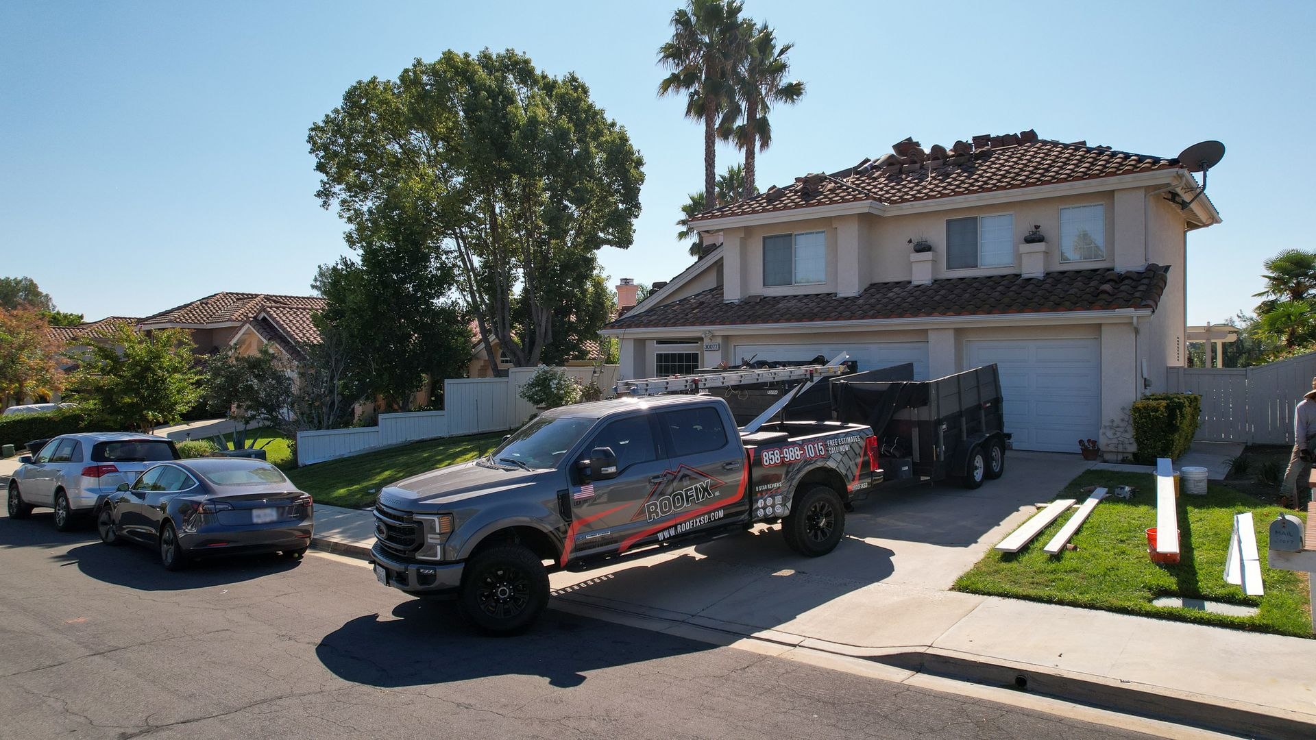 A gray truck is parked in front of a house