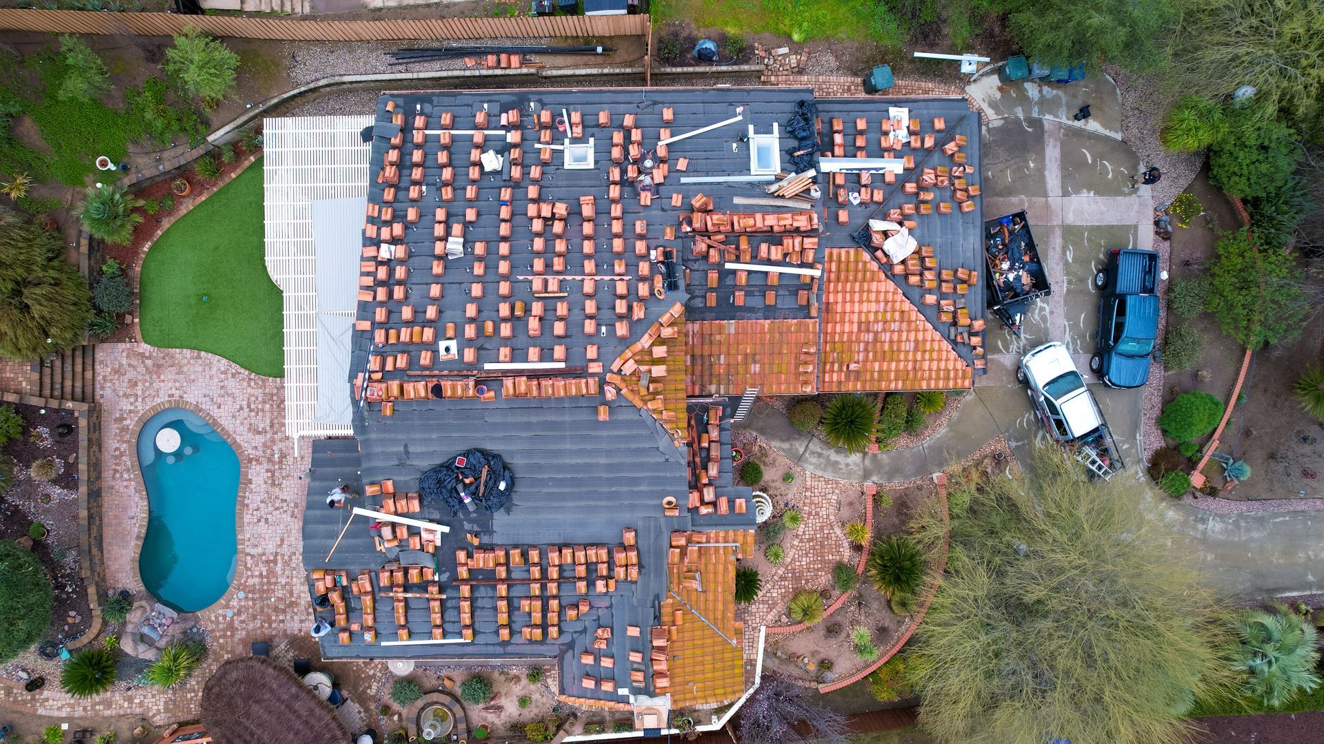 An aerial view of a house with a pool in the backyard