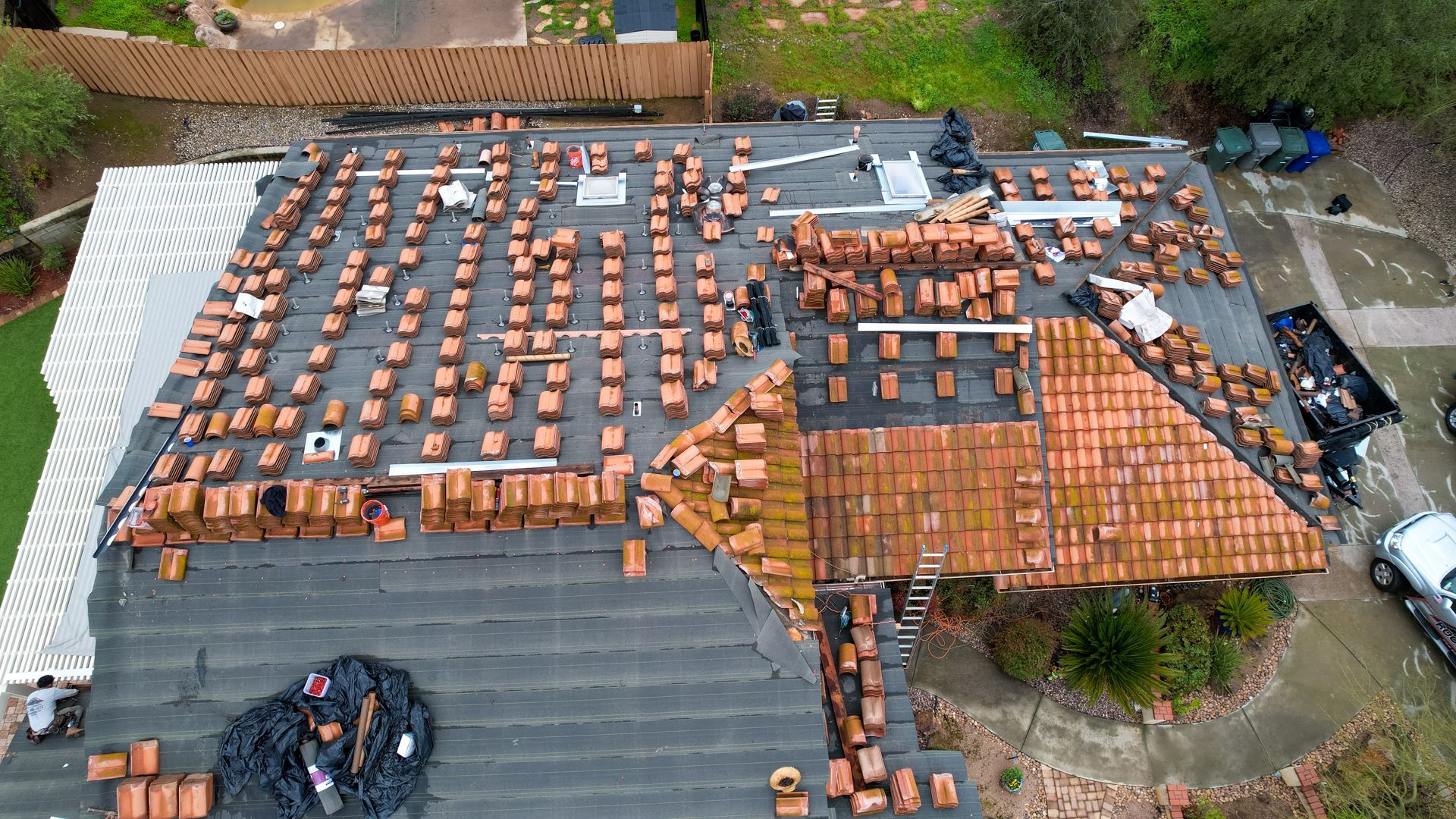 An aerial view of a roof that is being repaired