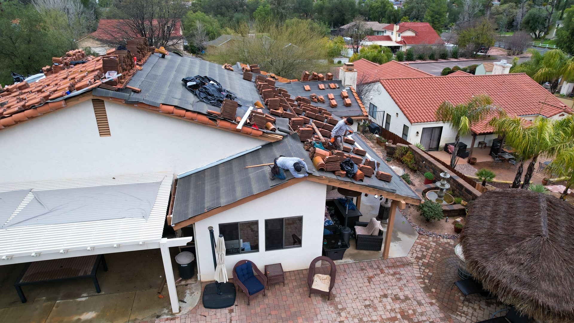 An aerial view of a house that has been damaged by a storm