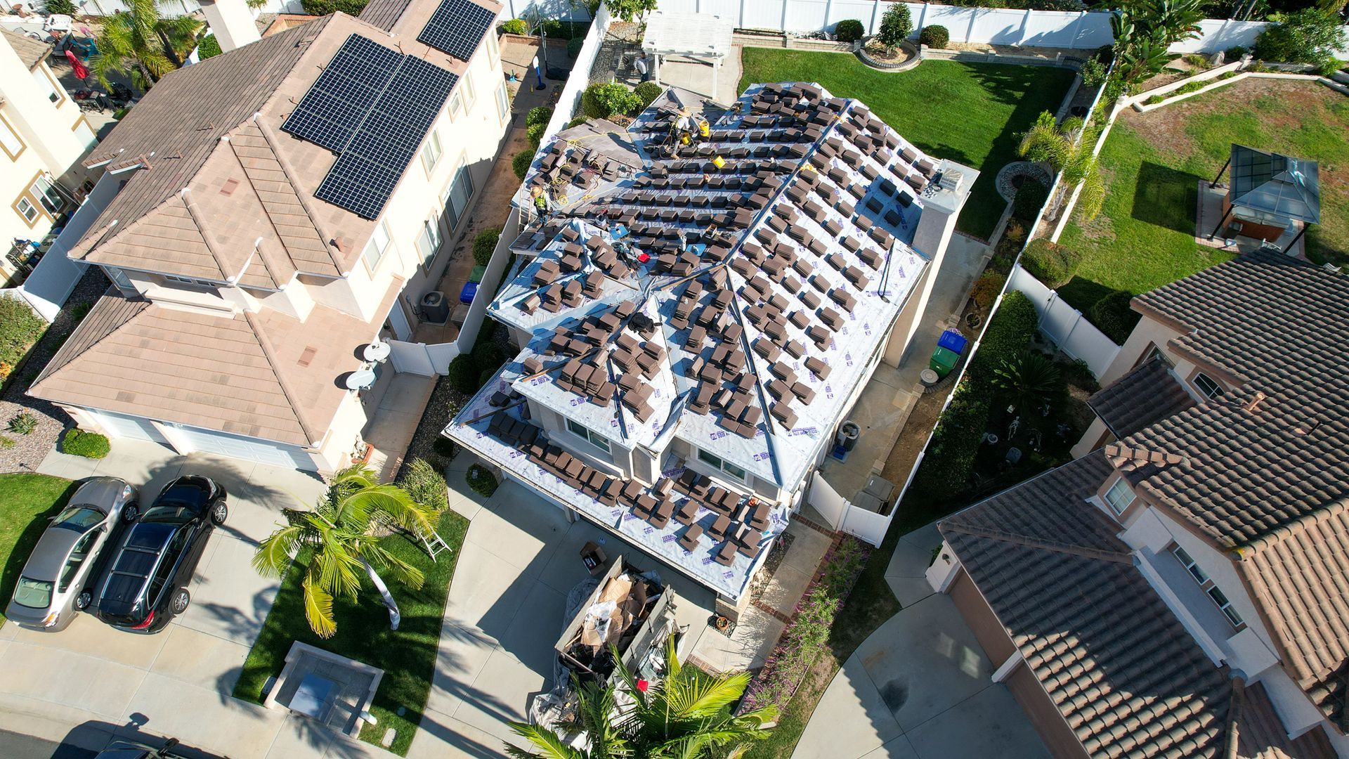 An aerial view of a house with solar panels on the roof