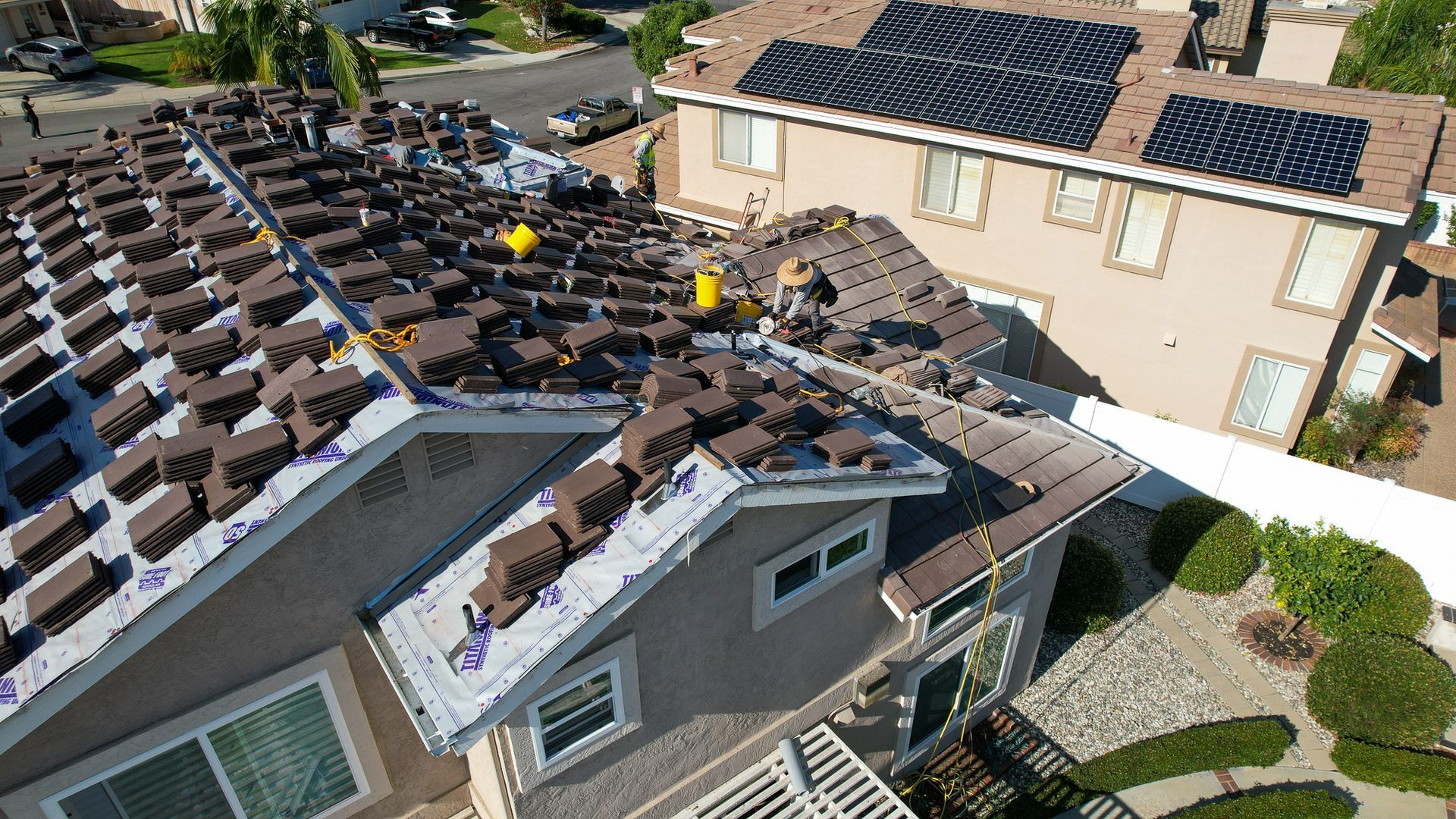 An aerial view of a house with solar panels on the roof