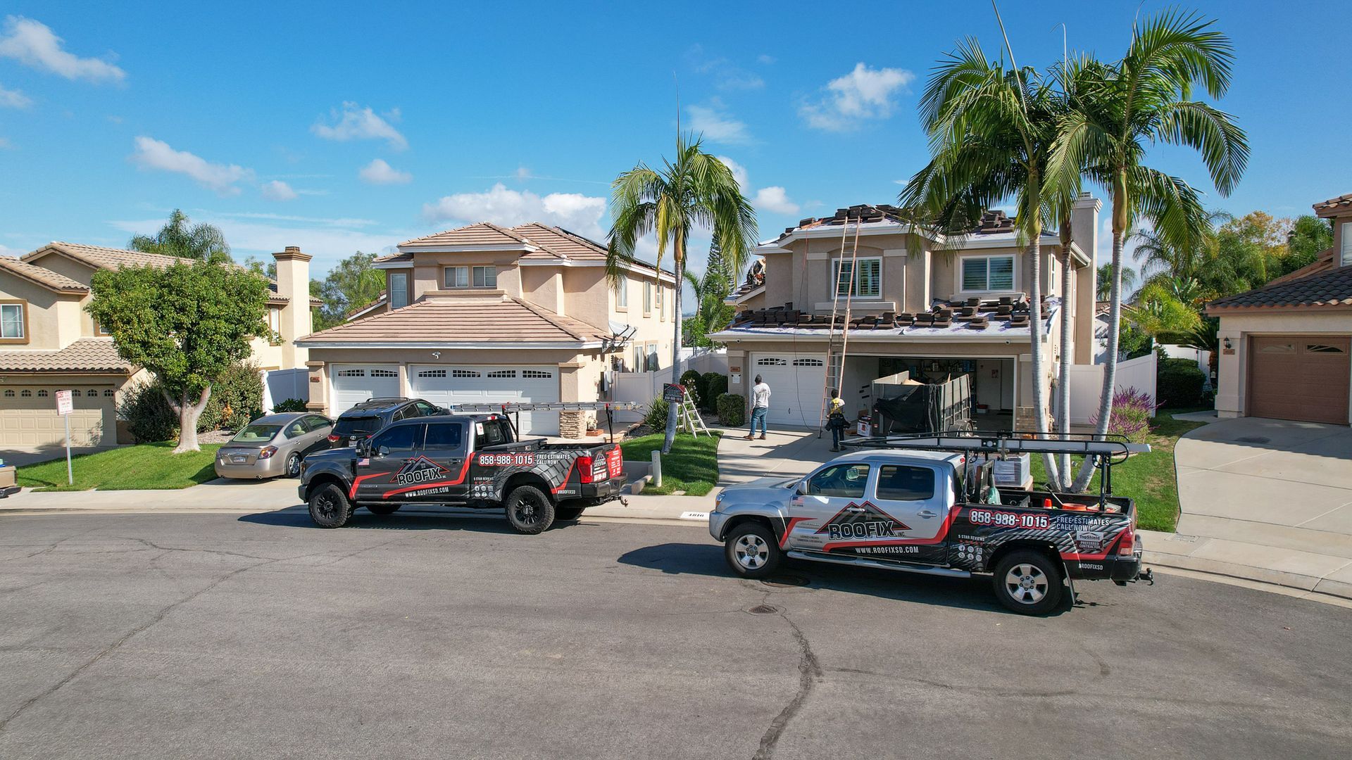 A couple of trucks parked in front of a house