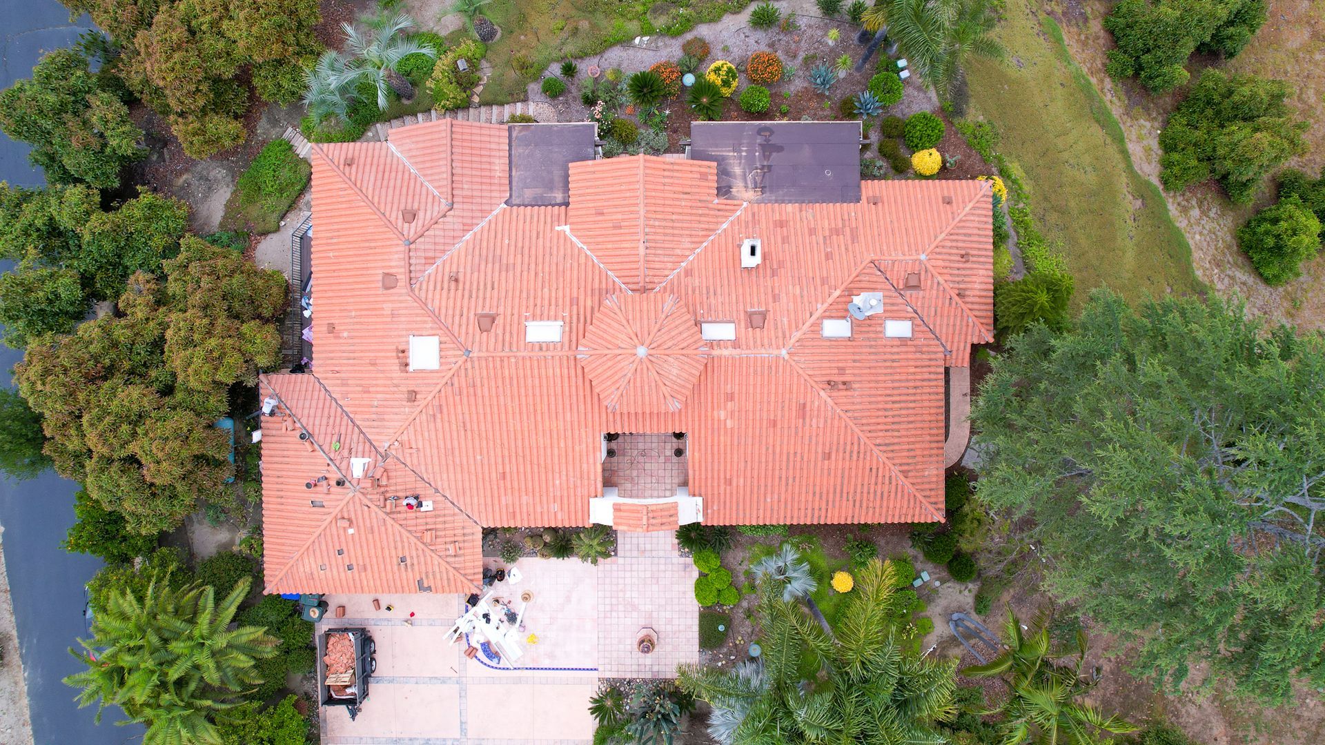 An aerial view of a house with a red tile roof